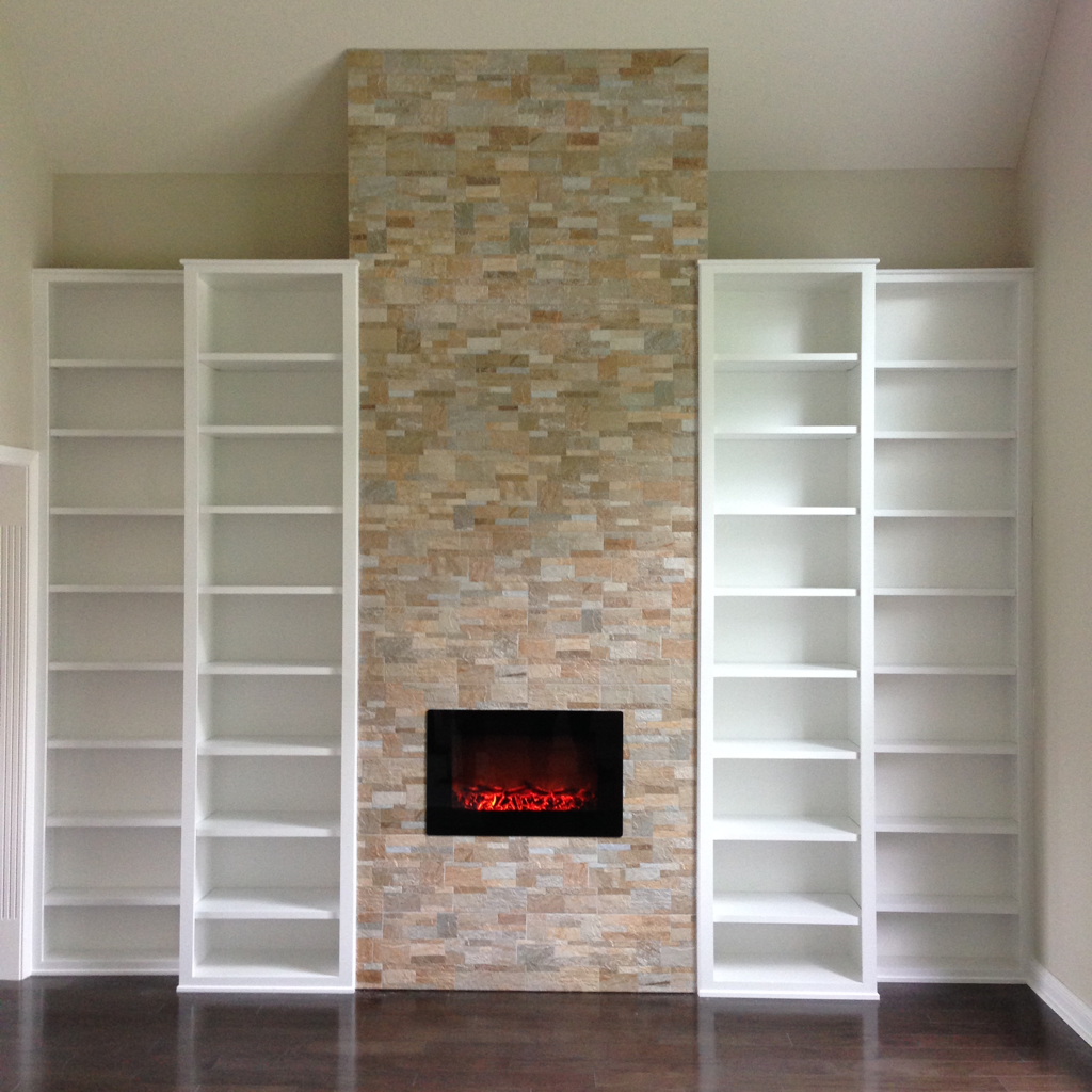 Formal living room built-in with faux stone ceramic tile fireplace with electric insert, bookcases with adjustable shelving. 